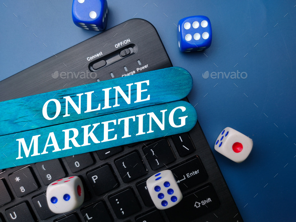 Keyboard and dice with the word ONLINE MARKETING. Business concept - Stock Photo - Images