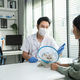 Asian veterinarian examine cat during appointment in veterinary clinic.  - PhotoDune Item for Sale