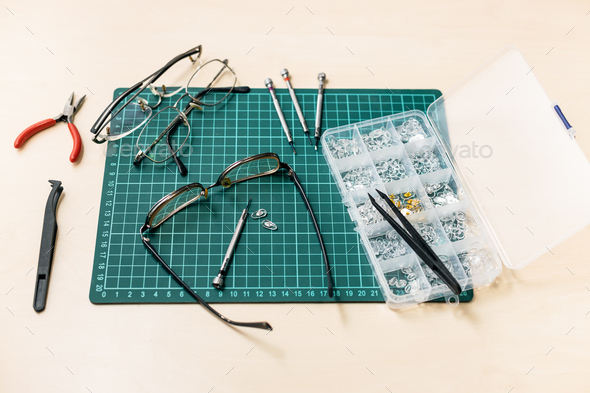 kit for repairing eyeglasses on wooden table - Stock Photo - Images