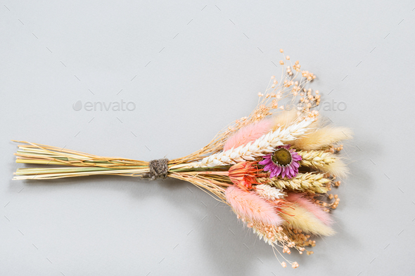 bouquet of dried flower and spikelets lies on gray - Stock Photo - Images