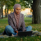 Muslim islamic ethnic student girl in hijab business woman freelancer worker uses laptop sitting on - PhotoDune Item for Sale