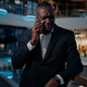 Sad ethnic middle-aged man African American entrepreneur answer phone call talking smartphone talk - PhotoDune Item for Sale