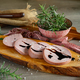 slices of Bologna PGI mortadella on wooden cutting board - PhotoDune Item for Sale