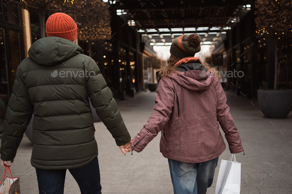 Couple in love shopping together at winter holidays - Stock Photo - Images