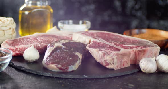 Pieces of Raw Beef with Garlic and Oil Slowly Rotate. alt