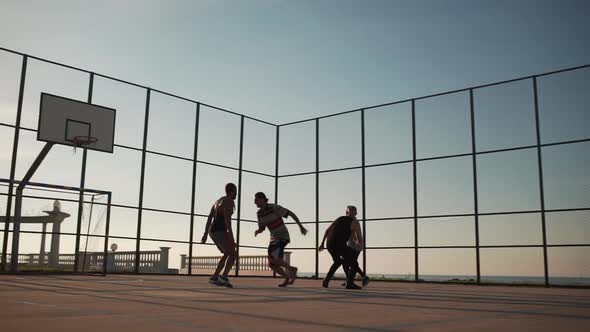 Sportive Happy People Playing Streetball on Sunlit Playground in Slowmotion alt