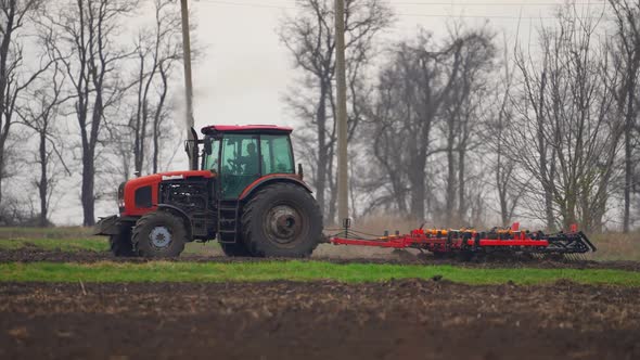 Agricultural Tractor Sowing and Cultivating Field alt