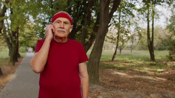 Senior Old Man Running in Park and Using Smart Watch, Tracking Result After Fitness Workout alt
