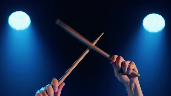 Closeup of Male Hands Beating Out the Rhythm with Drumsticks alt
