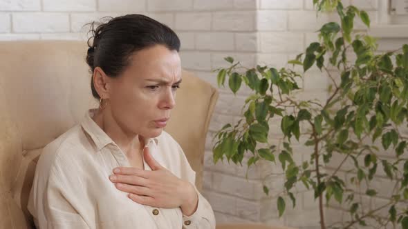 Stressed woman with hard breathing at home.  alt