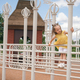 A little two-year-old girl climbs metal works on the playground. - PhotoDune Item for Sale