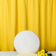 Cosmetic podium, pedestal on a bright yellow curtain background - PhotoDune Item for Sale
