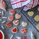 Flat lay of valentines heart cookies being baked and baking utensils on gray background  - PhotoDune Item for Sale