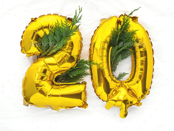20 golden foil balloon number party bunting on white cloth - Stock Photo - Images