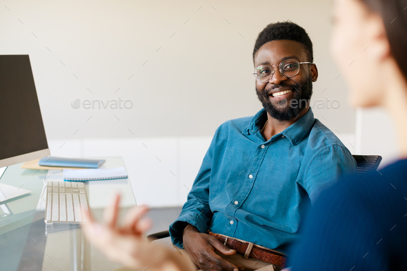 African american personnel manager and young female job applicant communicating on work interview at - Stock Photo - Images