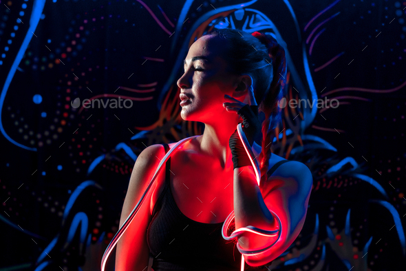 A young woman in fashionable youth club clothes in neon light. neon lights. Nightlife