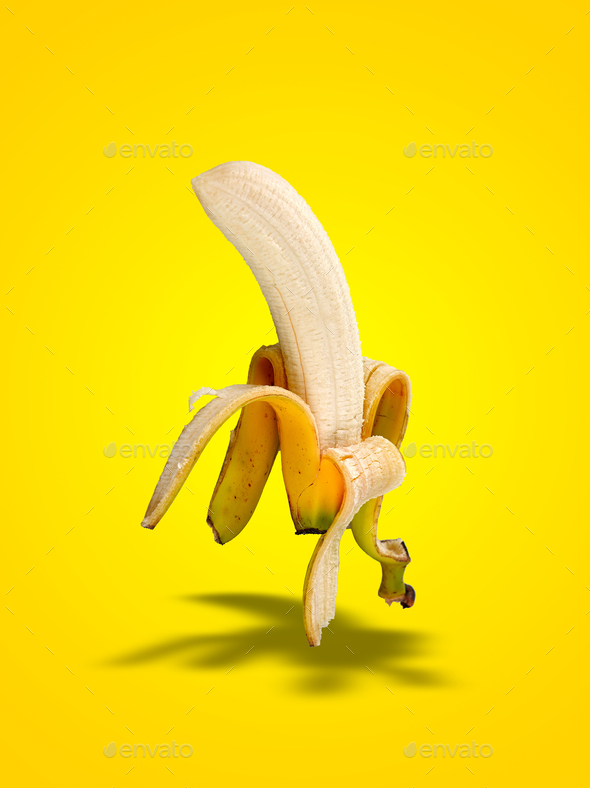 Banana Peel  with shadows on yellow gradient - Stock Photo - Images