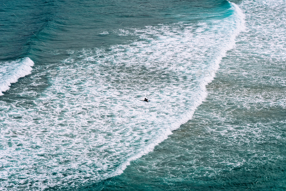 Aerial view of surfers surfing waves in Beach of Antuerta in Ajo - Stock Photo - Images