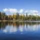 Blue trout lake with trees in autumn color in northern Minnesota on a sunny day - PhotoDune Item for Sale
