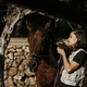 Brunette girl preparing the horse for riding. - PhotoDune Item for Sale