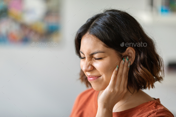Sick young arab woman having ear pain at home