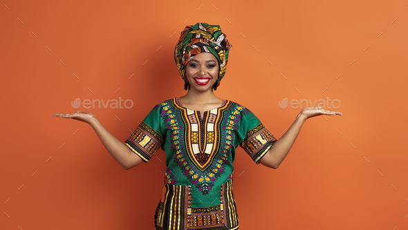 Pretty traditional african woman holding something on both hands