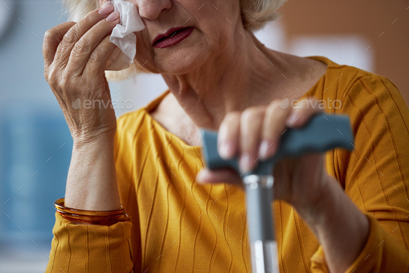 Close up of elderly woman crying in therapy session