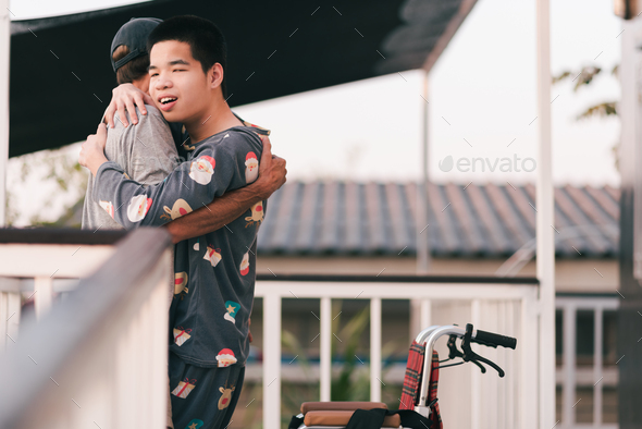 Teenager boy on wheelchair in the outdoor activity, Family Caregiving and diverse family concept. - Stock Photo - Images