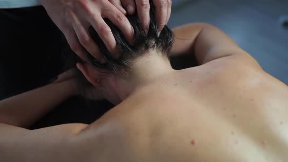 Masseur Man Makes a Head Massage for a Woman. alt
