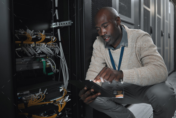 Data center or black man on tablet in server room on database maintenance or software update. Cyber
