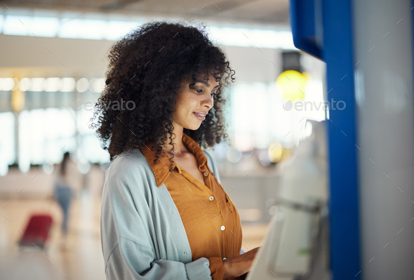 Black woman, airport and self service kiosk for ticket, registration or online boarding pass. Afric
