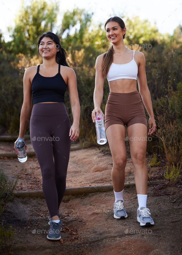 Fitness women or friends walking in nature with water bottle for workout, running and cardio traini