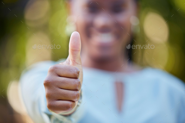 Hand, closeup and thumbs up by black woman showing yes, recommendation or thank you on bokeh backgr