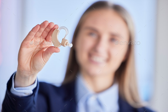 Hands, hearing aid and deaf business woman with listening device for healthcare, wellness and disab