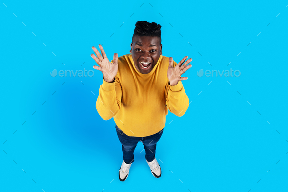 Top View Of Excited Black Guy Spreading Hands With Surprise - Stock Photo - Images