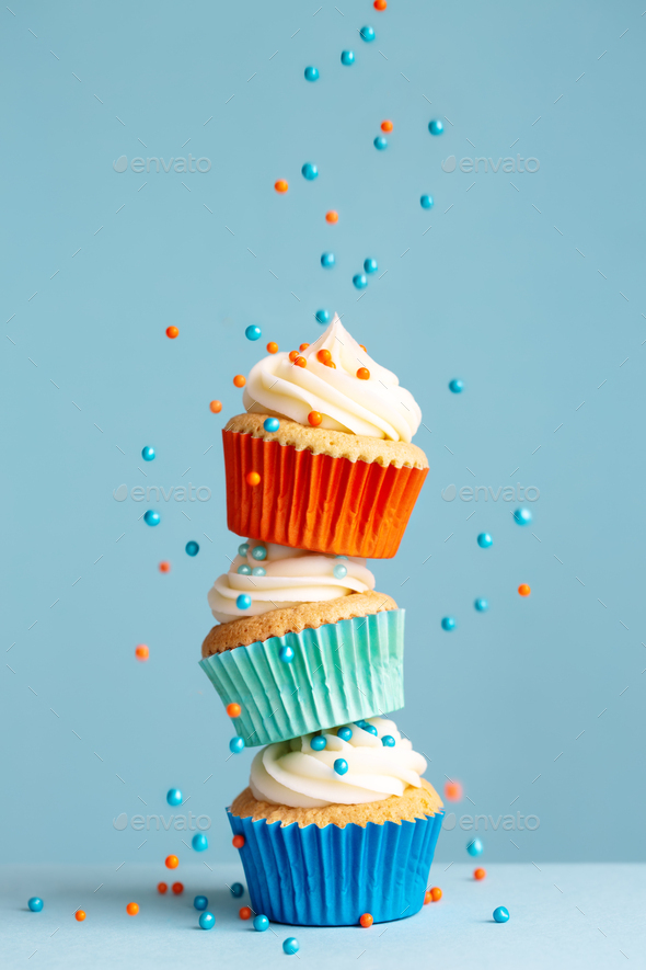 Stack of cupcakes with falling sprinkles - Stock Photo - Images
