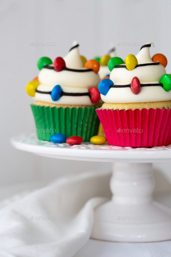 Cakestand with Christmas cupcakes decorated with Christmas lights - Stock Photo - Images