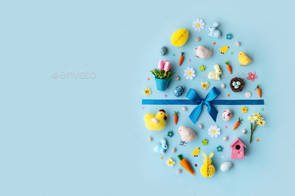 Easter objects laid out in the shape of an Easter egg - Stock Photo - Images
