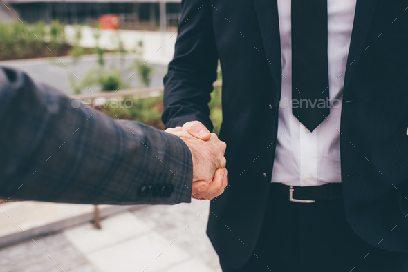 Close up professional businessmen shake hand with partner - Stock Photo - Images