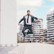 Energetic young bearded professional businessman jumping in mid-air - PhotoDune Item for Sale