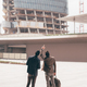 Two young contemporary businessmen back view outdoors city looking cityscape - PhotoDune Item for Sale