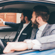 Two elegant contemporary bearded businessmen taking selfie seated in car - PhotoDune Item for Sale