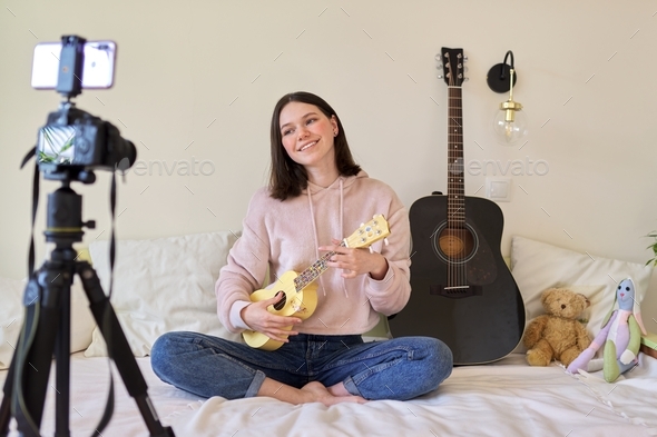 Teen girl playing on ukulele. Blog, music channel, vlog,