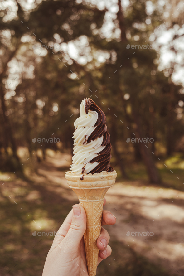 Female Hand Holding Delicious American Vanilla Chocolate Ice Cream