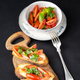 Tasty bruschettas with cherry tomatoes on a wooden board - PhotoDune Item for Sale