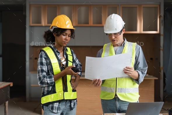 Engineer team discussing meeting on plan at construction site - Stock Photo - Images