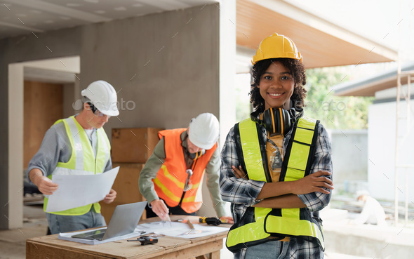 portrait female engineer project manager with construction gear and project blueprint Architecture - Stock Photo - Images