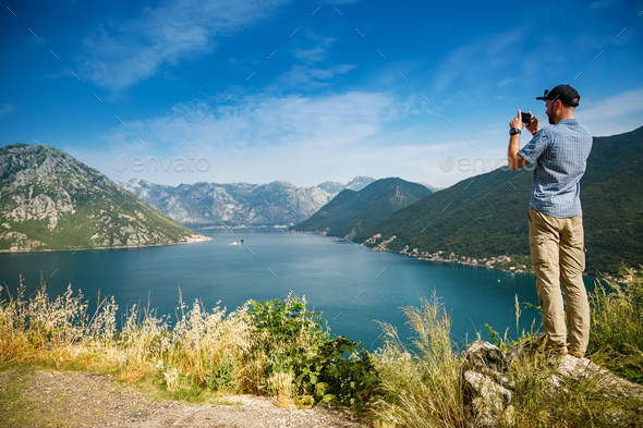 Tourist man taking a picture of the Bay of Kotor, Montenegro