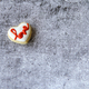 Minimalistic overhead view of a heart shaped cookie with the word love in red on gray background  - PhotoDune Item for Sale