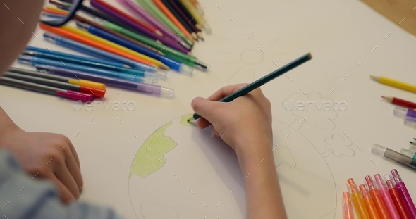 Child boy draws planet for earth day. Protection of enviroment, Mother ...